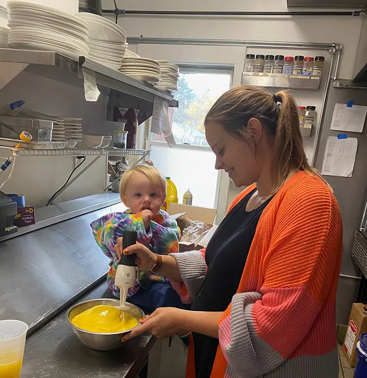 Photo of Leeann Barton cooking with her son